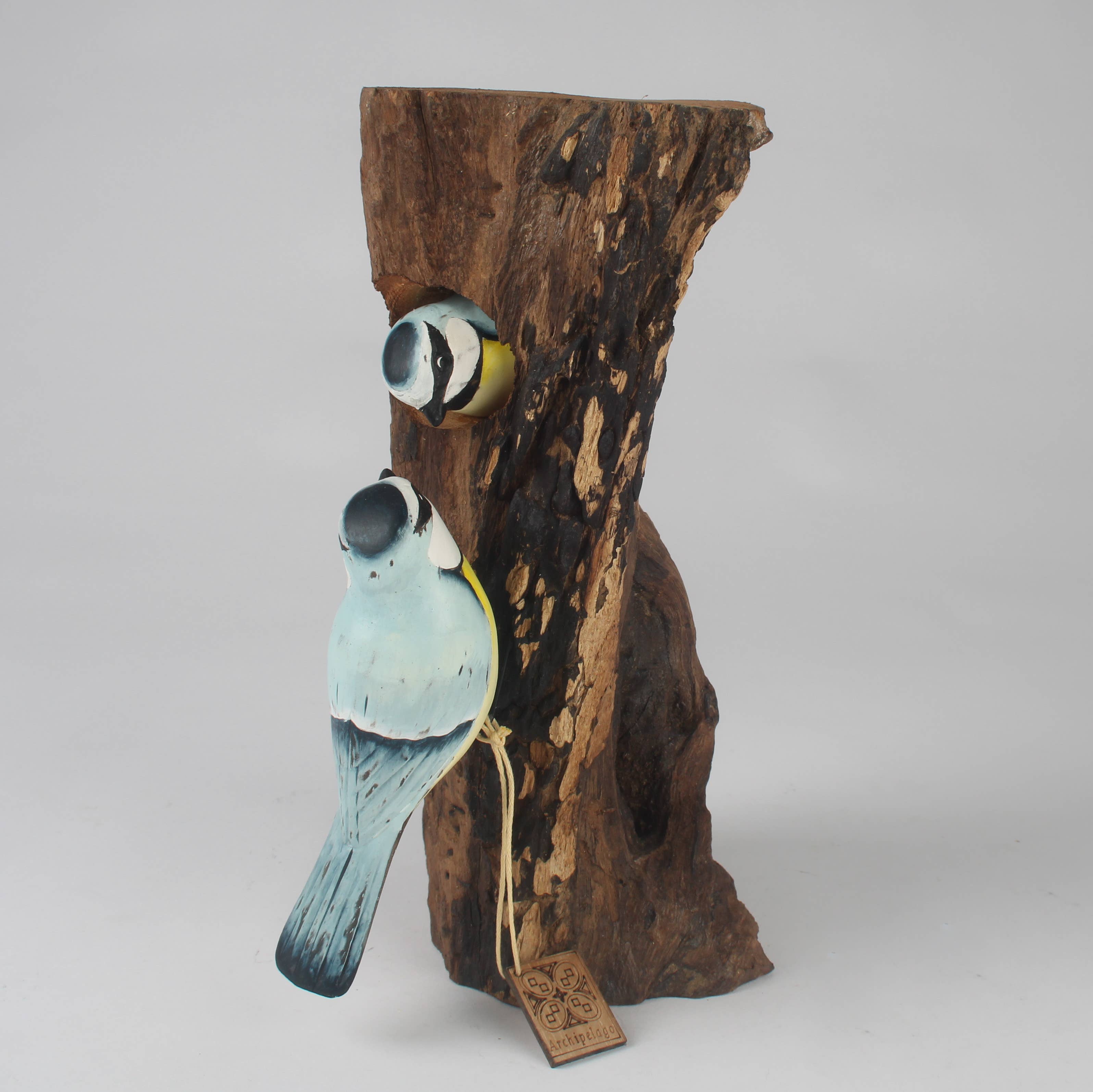 Hand Carved Blue Tit Family on Tree Stump by Archipelago